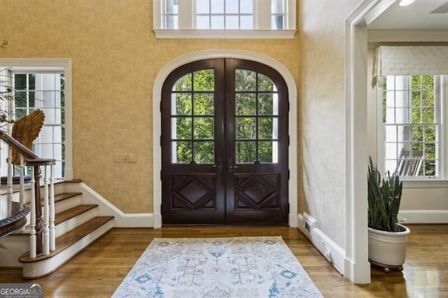 foyer entrance featuring hardwood / wood-style floors and french doors