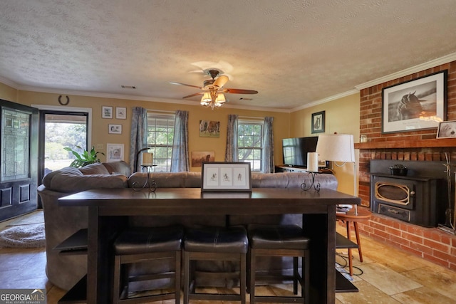 dining area with crown molding, ceiling fan, and a textured ceiling