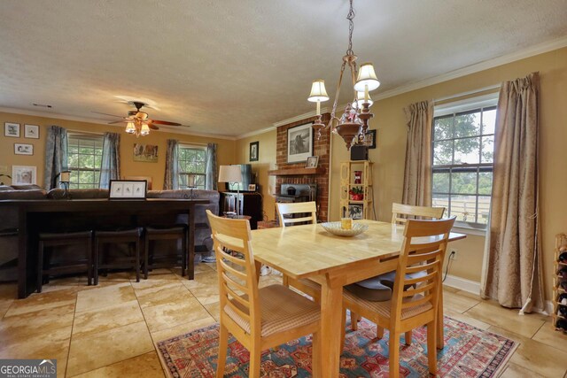 dining room featuring a textured ceiling, ceiling fan with notable chandelier, and ornamental molding