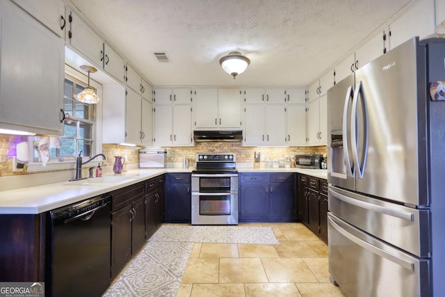 kitchen featuring light countertops, appliances with stainless steel finishes, a sink, and under cabinet range hood