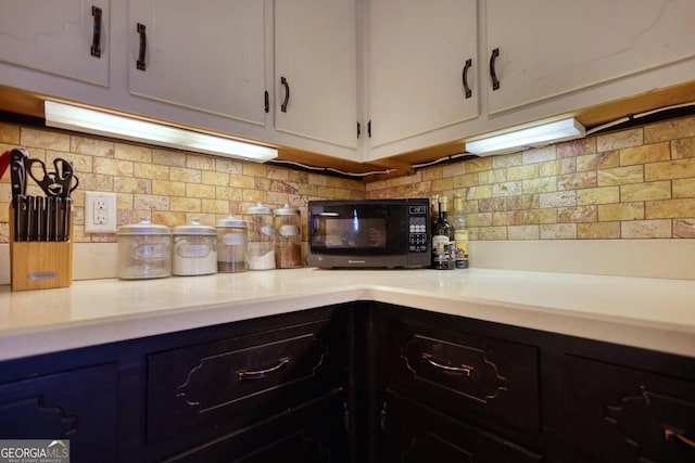 kitchen featuring white cabinets and tasteful backsplash