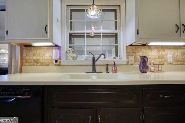 kitchen with dishwasher, backsplash, sink, hanging light fixtures, and white cabinetry