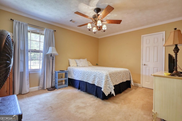 bedroom featuring crown molding, visible vents, light carpet, a textured ceiling, and baseboards