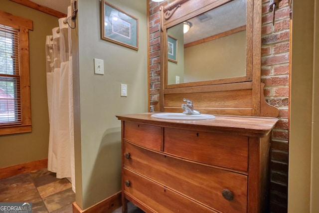 full bathroom featuring vanity and baseboards