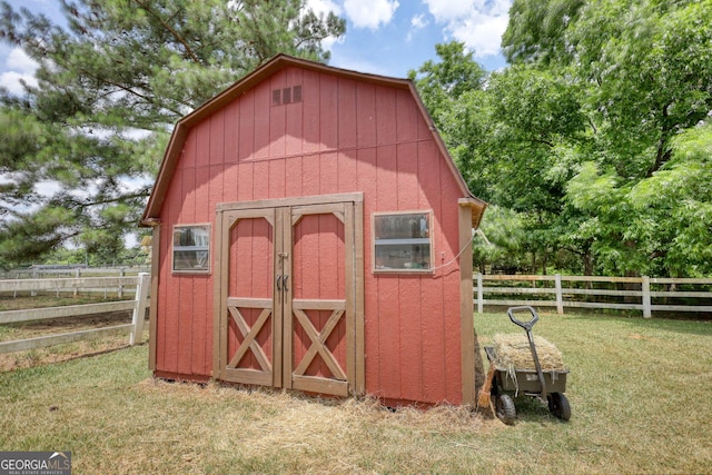 view of outbuilding featuring a yard