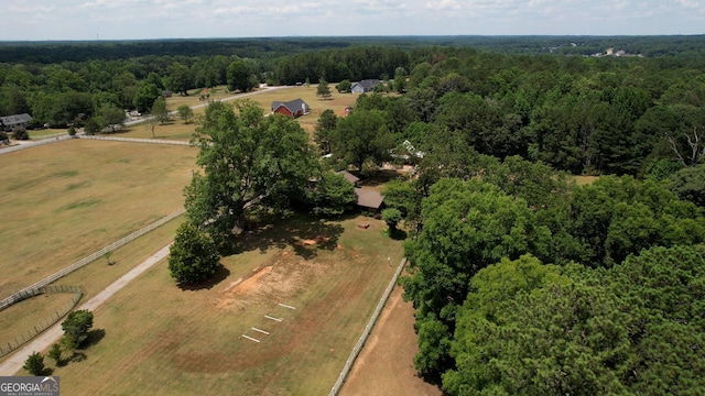 birds eye view of property with a view of trees and a rural view