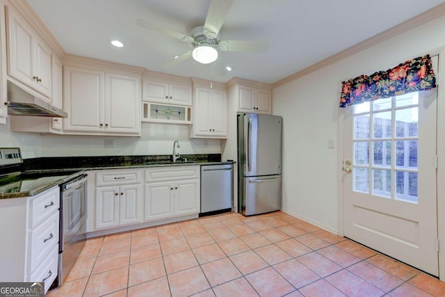 kitchen with appliances with stainless steel finishes, white cabinetry, sink, dark stone counters, and ornamental molding