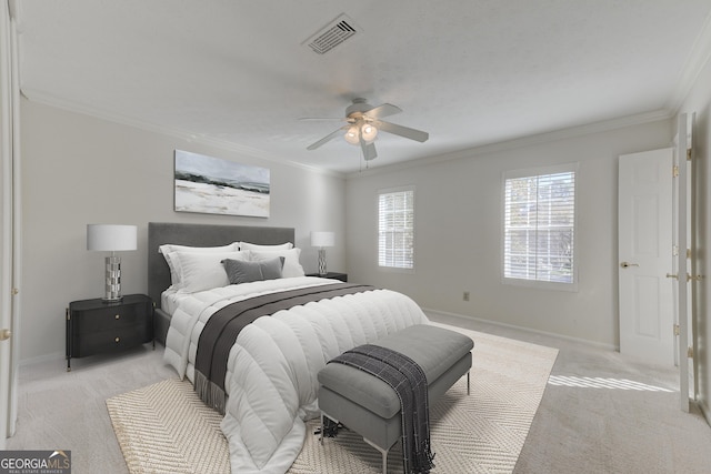 bedroom featuring ornamental molding, light carpet, and ceiling fan