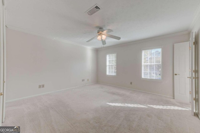 unfurnished room featuring crown molding, light carpet, and ceiling fan