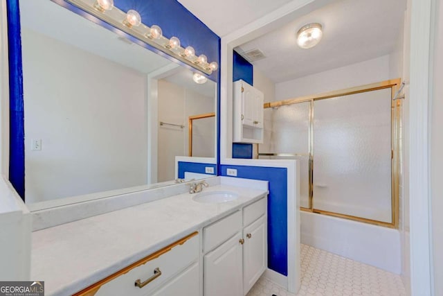 bathroom with vanity and shower / bath combination with glass door