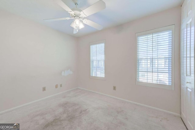 carpeted empty room with ceiling fan