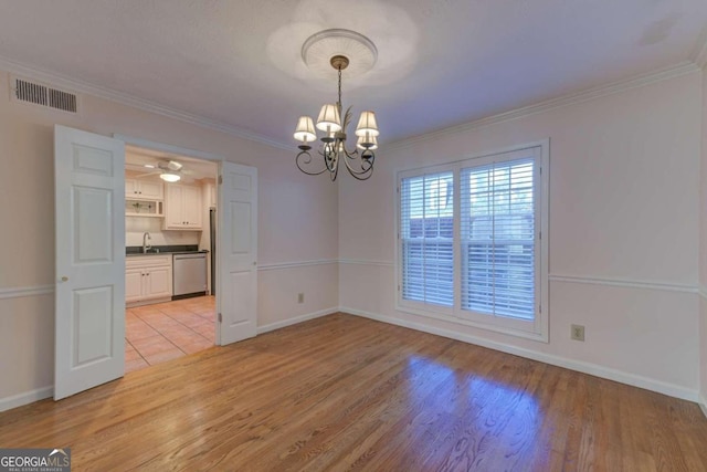 empty room with ornamental molding, sink, ceiling fan with notable chandelier, and light hardwood / wood-style flooring