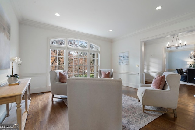 dining area with dark hardwood / wood-style floors, crown molding, and a notable chandelier