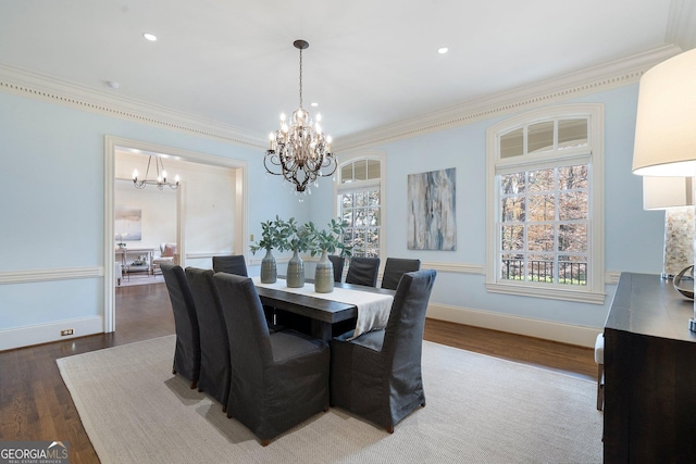 dining room with a chandelier, dark wood-type flooring, and ornamental molding