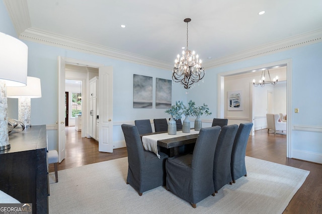 dining area featuring a chandelier, crown molding, and dark wood-type flooring