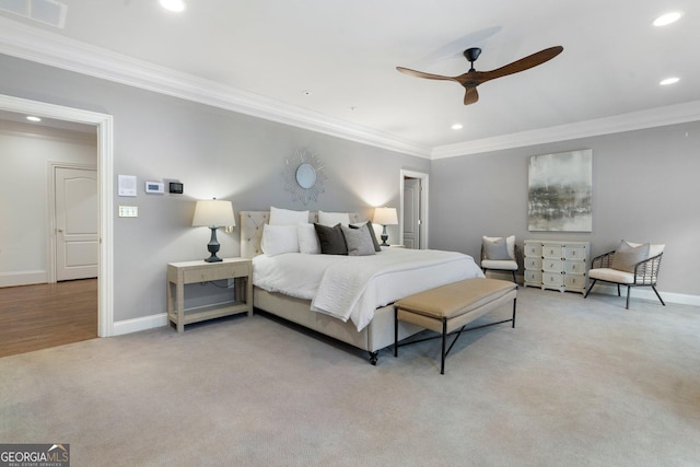 bedroom featuring ceiling fan, crown molding, and light carpet