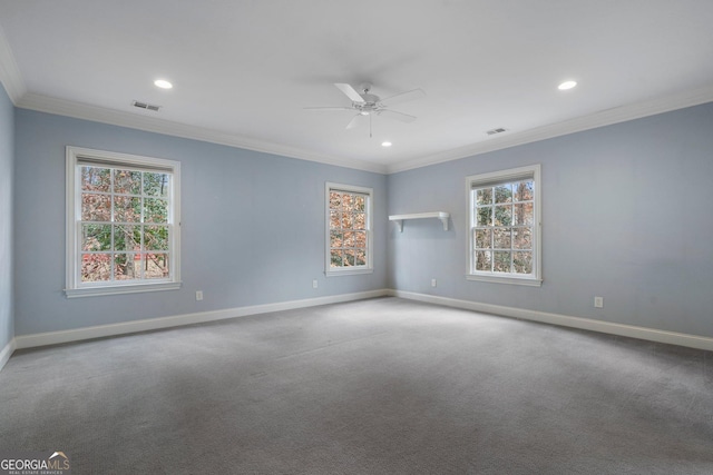 carpeted empty room featuring ceiling fan, plenty of natural light, and ornamental molding