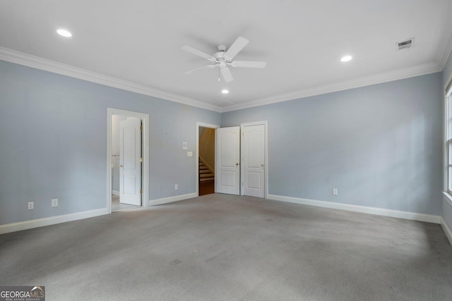 interior space with ceiling fan, light colored carpet, and crown molding