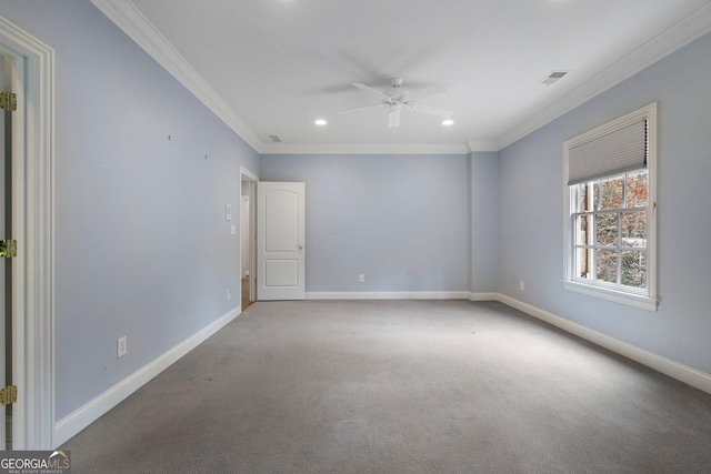 carpeted spare room featuring ceiling fan and crown molding