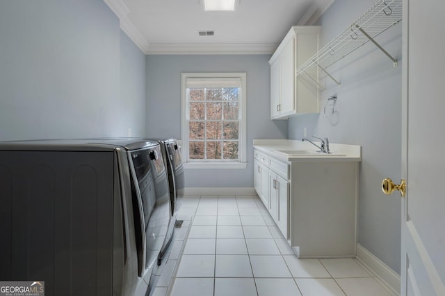 laundry area featuring cabinets, ornamental molding, washer and clothes dryer, sink, and light tile patterned flooring