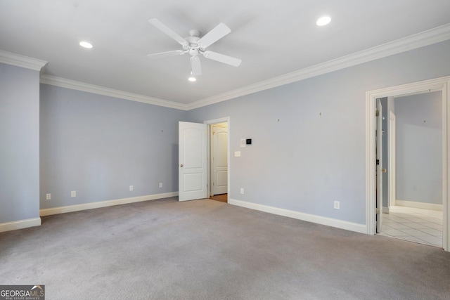 unfurnished bedroom featuring ceiling fan, crown molding, and light carpet