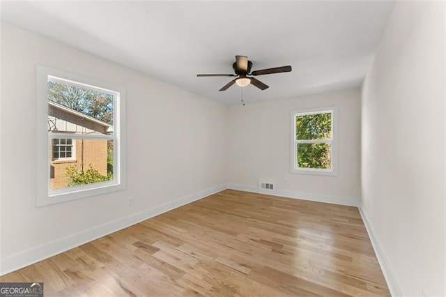 unfurnished room with light wood-type flooring and ceiling fan