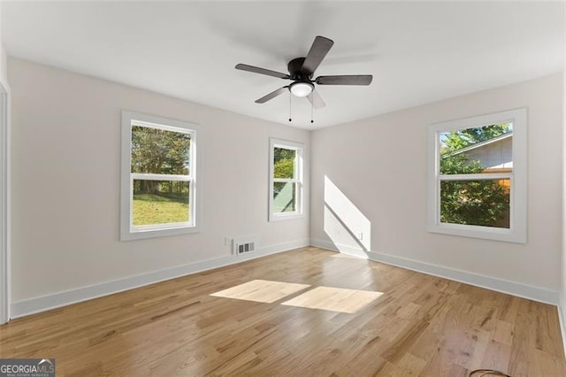 empty room featuring ceiling fan and light hardwood / wood-style floors