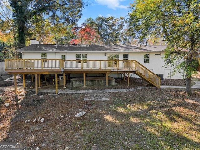 rear view of house featuring a deck