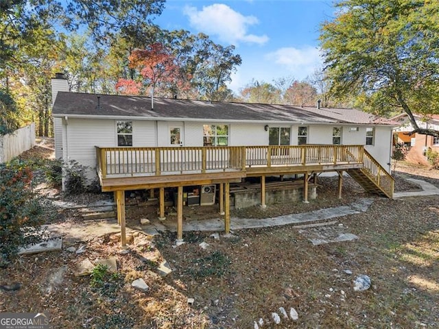 rear view of house featuring a deck