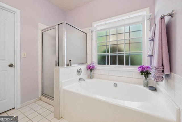 bathroom with separate shower and tub, a textured ceiling, and tile patterned floors