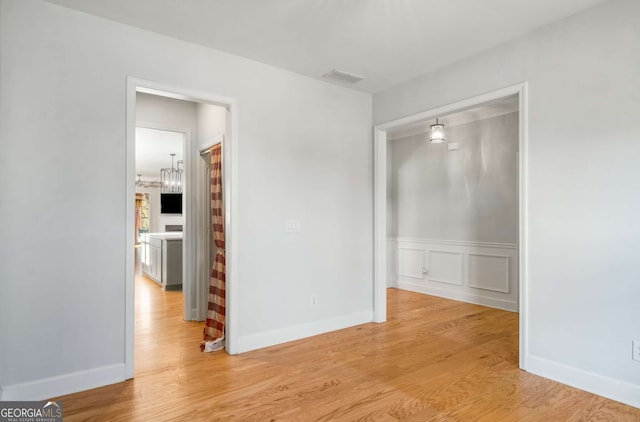 spare room with light wood-type flooring