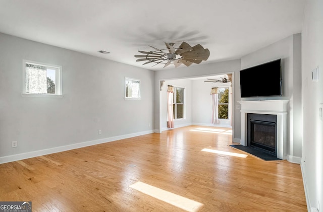 unfurnished living room featuring light hardwood / wood-style floors and plenty of natural light