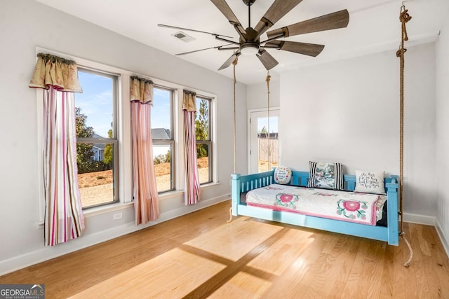 sitting room with ceiling fan and wood-type flooring