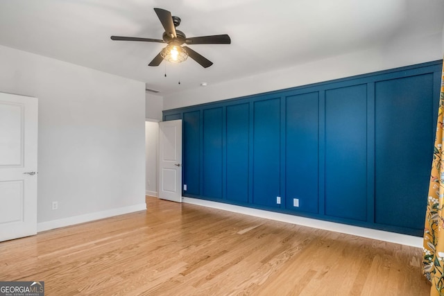 unfurnished bedroom with ceiling fan and light hardwood / wood-style flooring