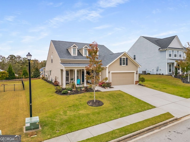 view of front facade with a garage, covered porch, and a front yard