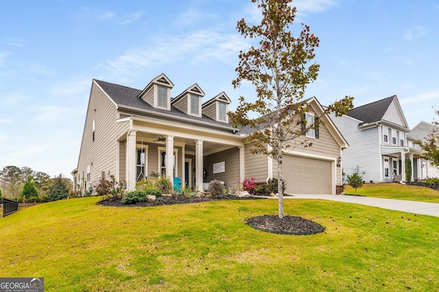 view of front of house featuring a front yard, a garage, and a porch