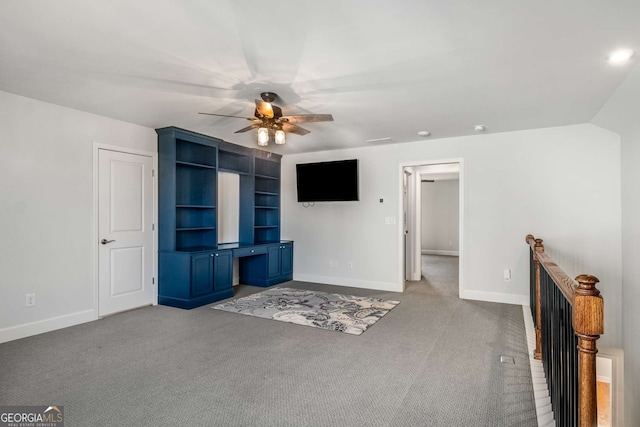 unfurnished living room with ceiling fan, carpet, and built in features