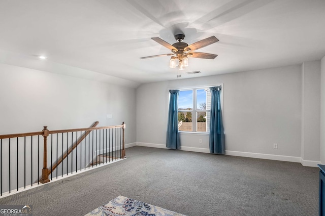 carpeted empty room with vaulted ceiling and ceiling fan