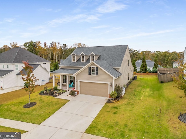 view of front of property featuring a front lawn, a garage, and covered porch