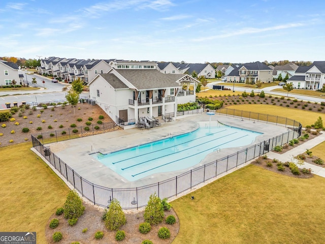 view of pool with a patio and a yard