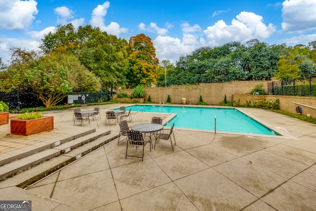 view of swimming pool with a patio area