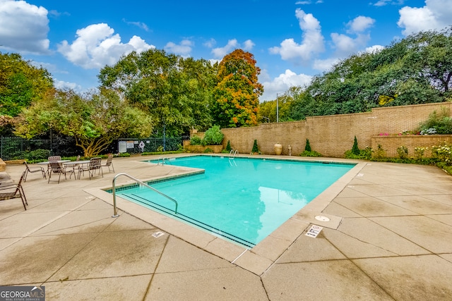 view of swimming pool with a patio area