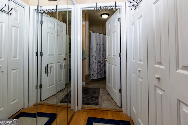 bathroom with hardwood / wood-style flooring and a shower with curtain