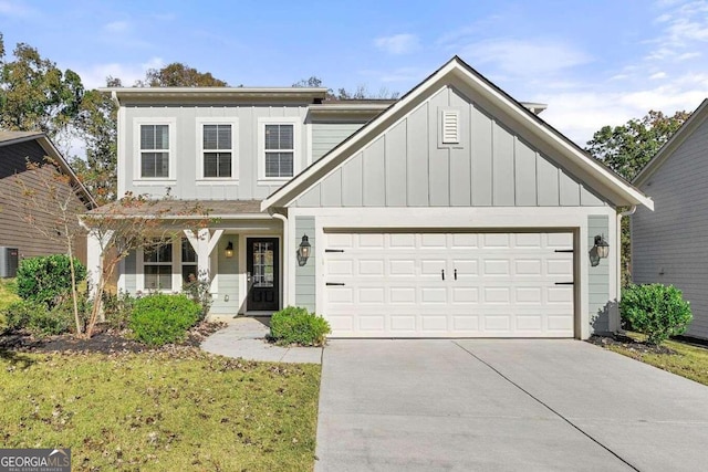 view of front of home featuring a garage and central AC unit