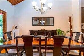 dining area featuring a chandelier and lofted ceiling