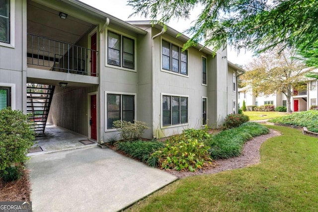 view of side of property with a yard and a carport