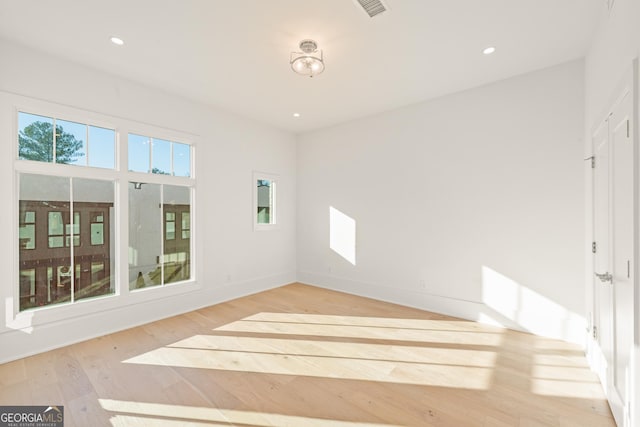 unfurnished room with recessed lighting, baseboards, and wood finished floors