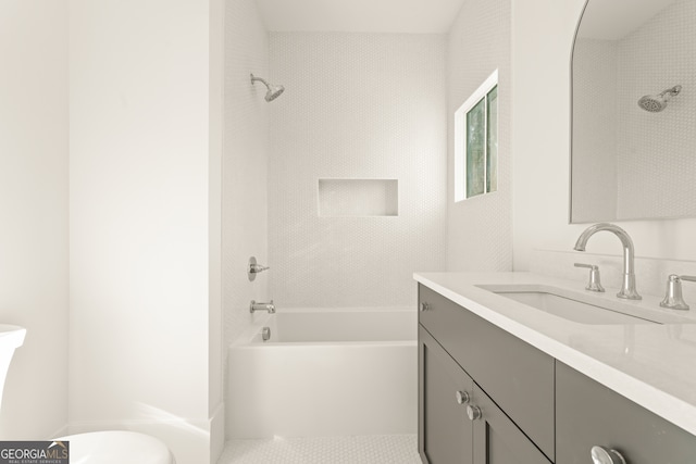 full bathroom featuring vanity, toilet, and tiled shower / bath