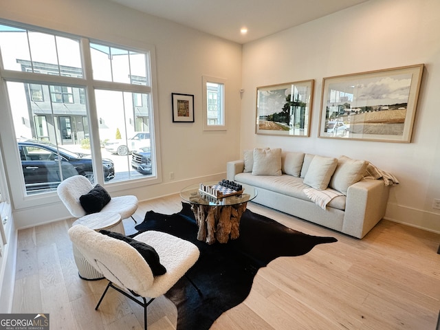 living area featuring recessed lighting, baseboards, plenty of natural light, and wood finished floors