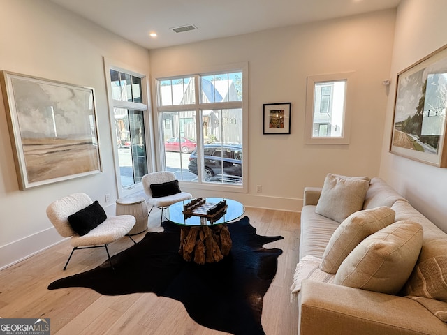 living area with recessed lighting, light wood-style floors, visible vents, and baseboards